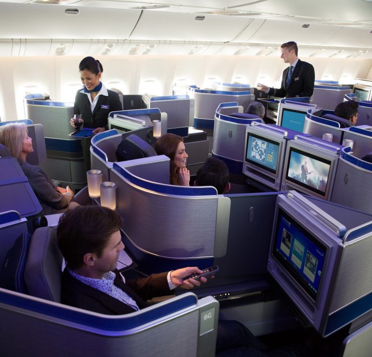 a group of people sitting in chairs in an airplane