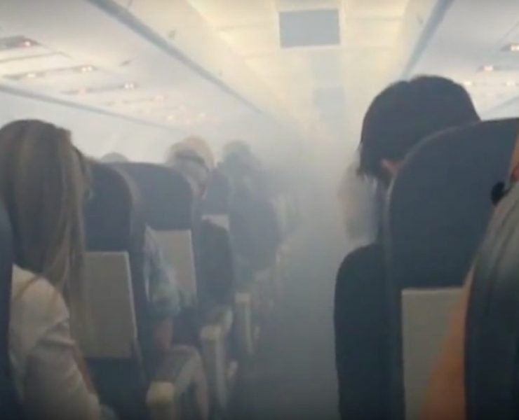 a group of people sitting in chairs in a plane