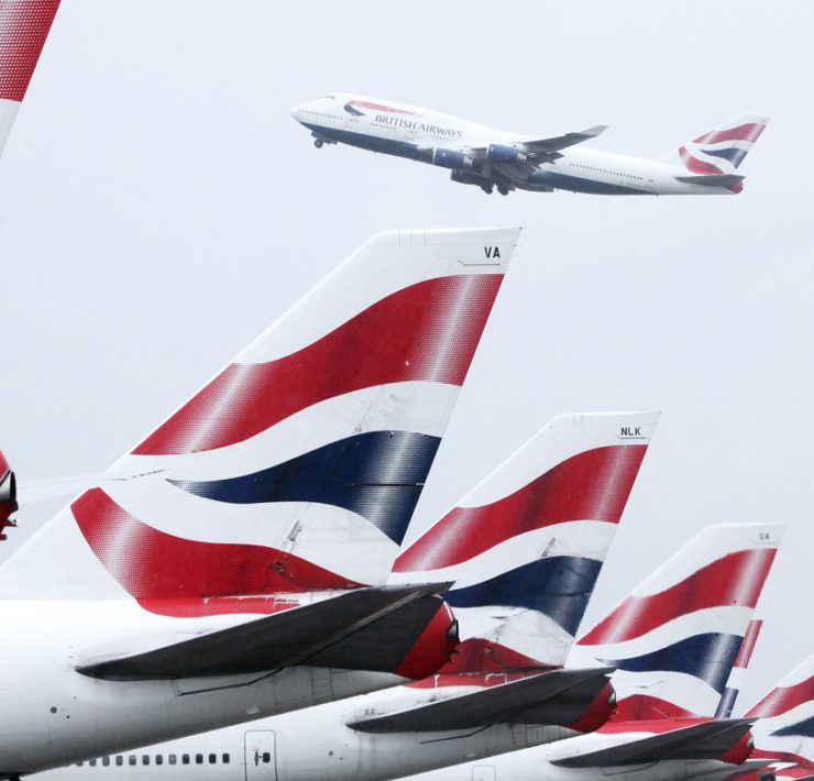 a group of airplanes with red white and blue tail fin