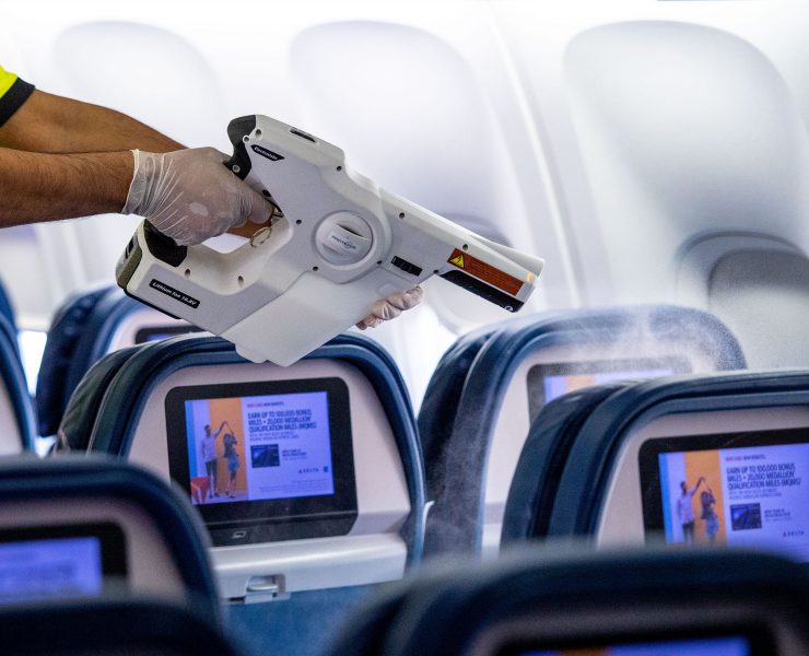 a person holding a gun in an airplane