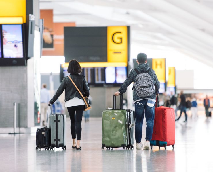 a man and woman with luggage in an airport