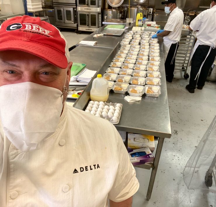 a man wearing a face mask in a kitchen