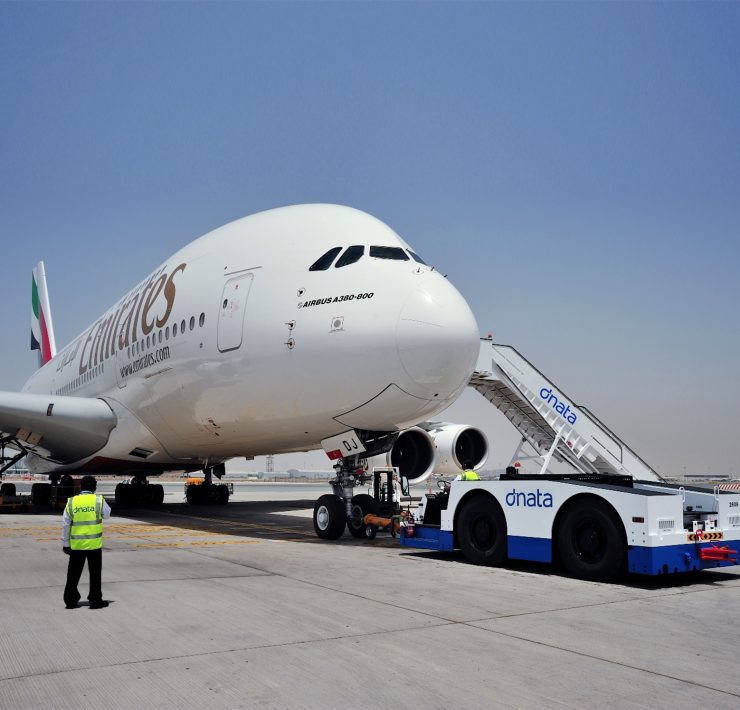 a large white airplane with a ladder on the front