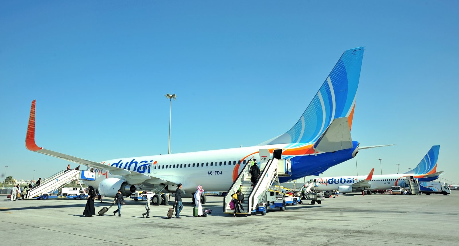 a group of people boarding an airplane