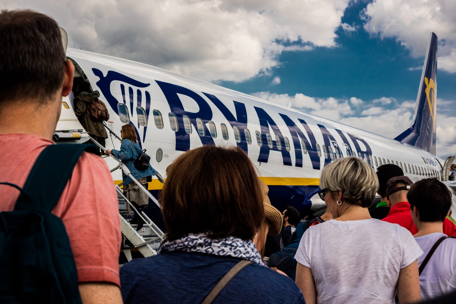 people standing on the stairs of an airplane