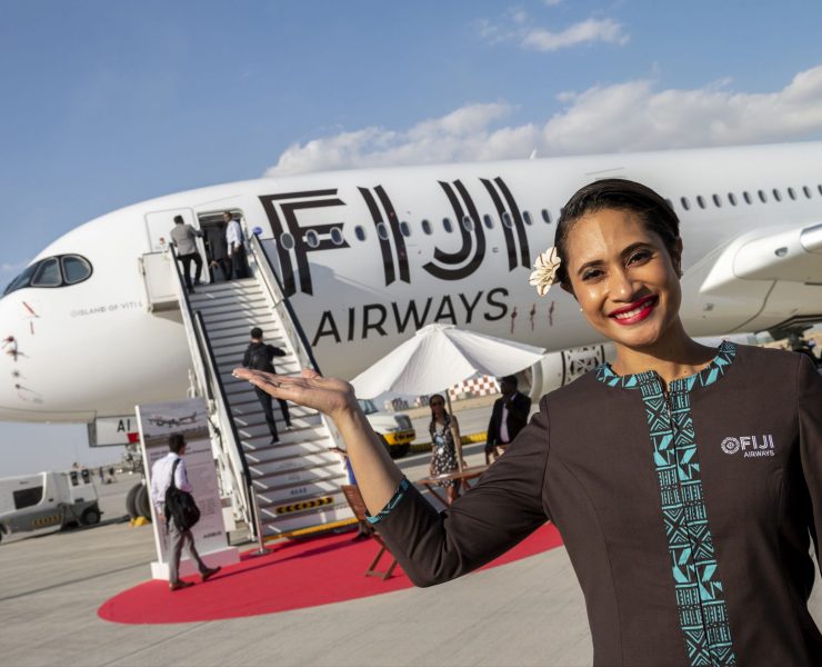 a woman standing in front of an airplane