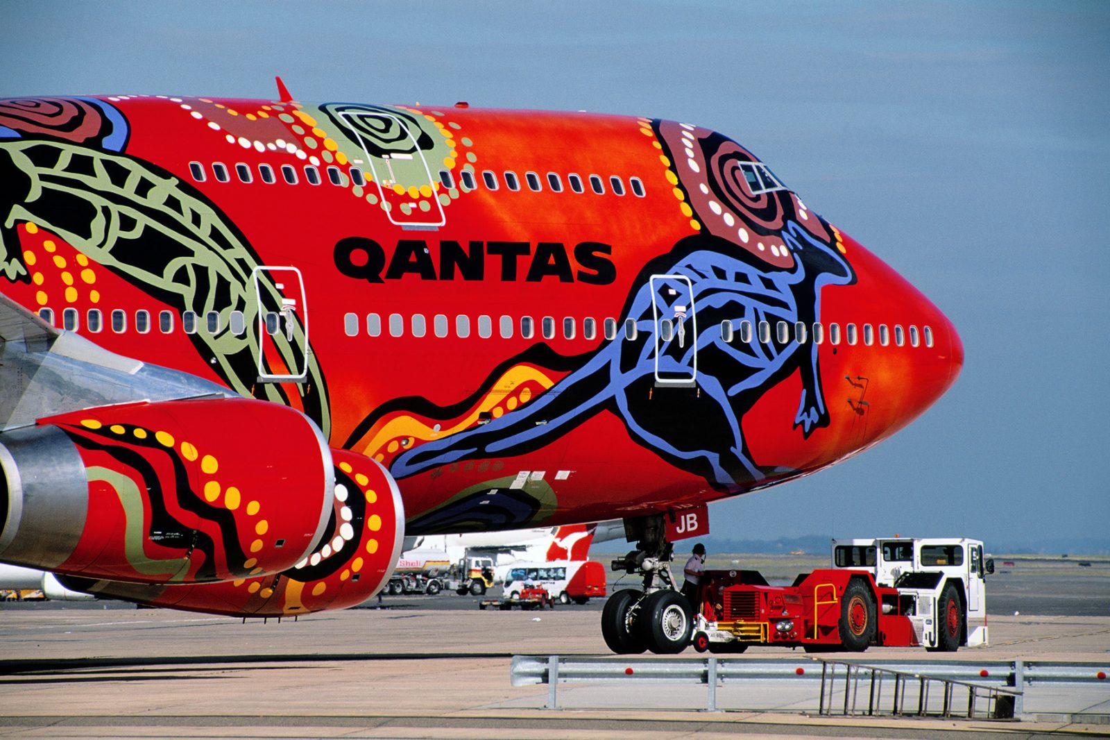 a red airplane with a colorful design on it