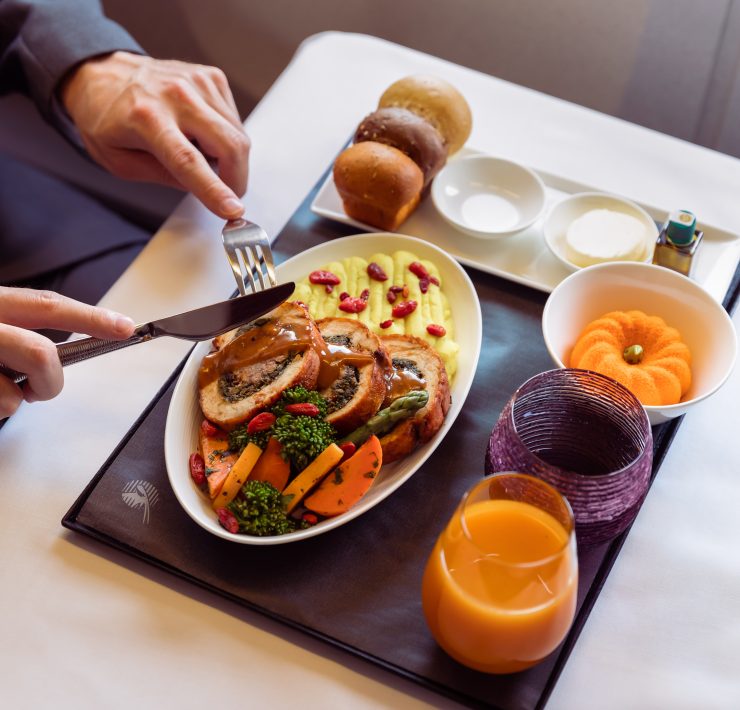 a person eating food on a tray