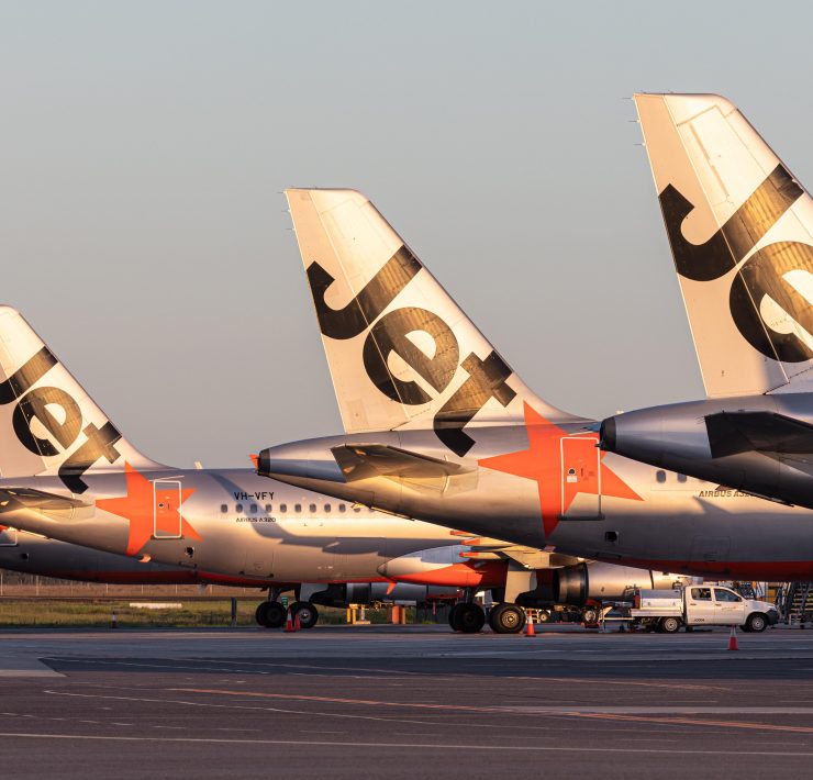 a group of airplanes parked on a runway