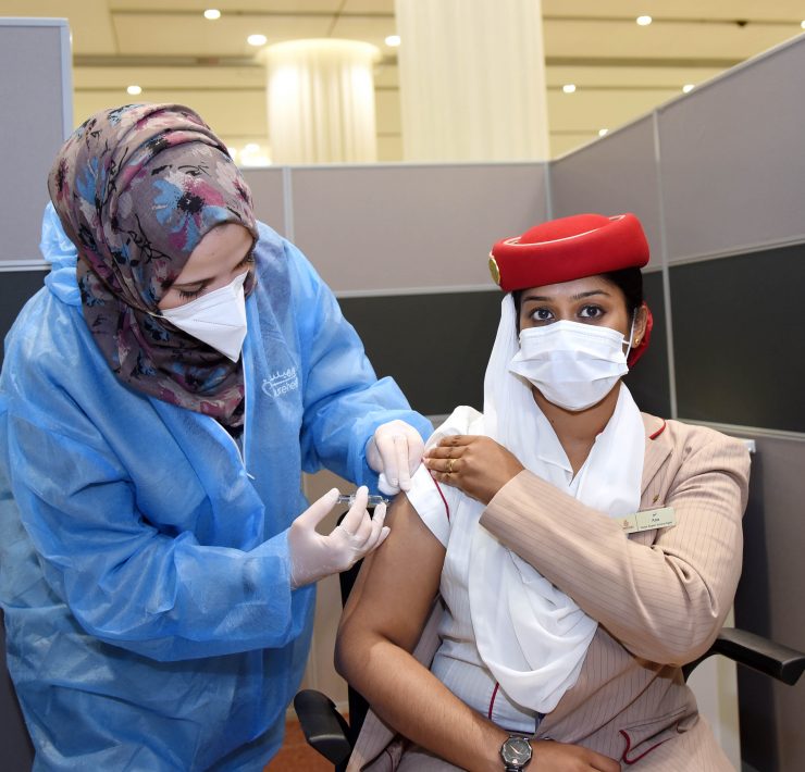 a woman in a medical uniform getting a shot of a patient