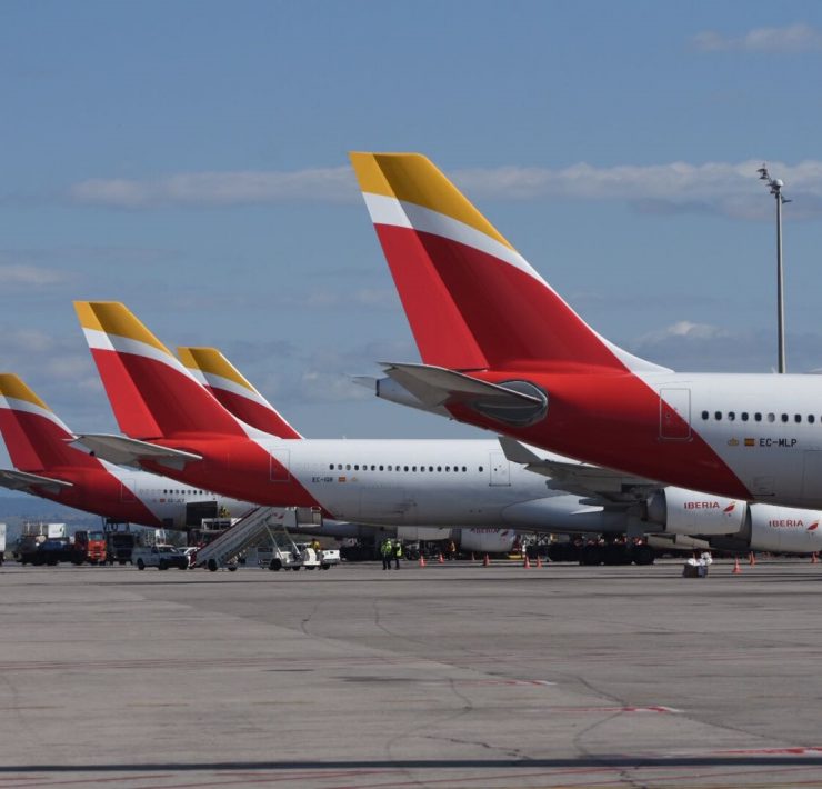 a row of airplanes parked on a runway