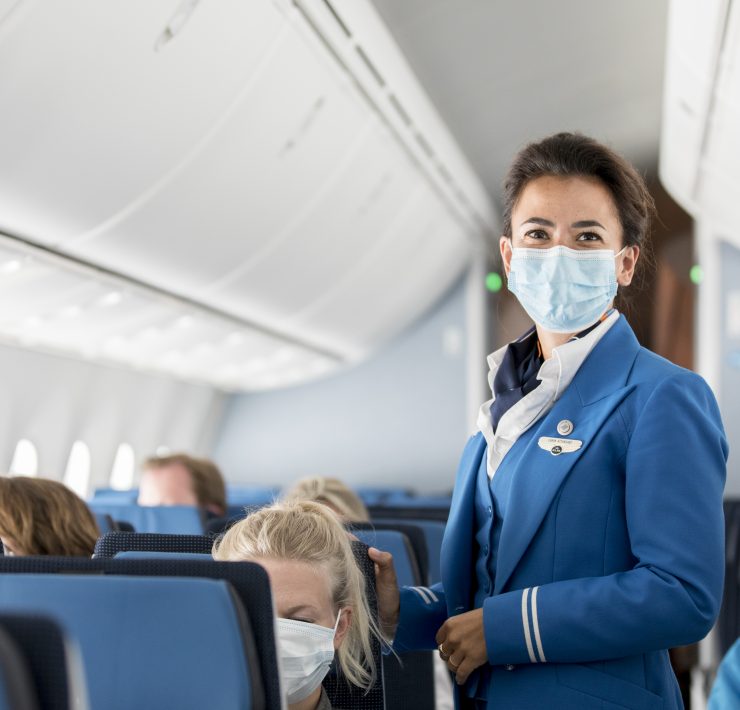 a woman wearing a mask on an airplane