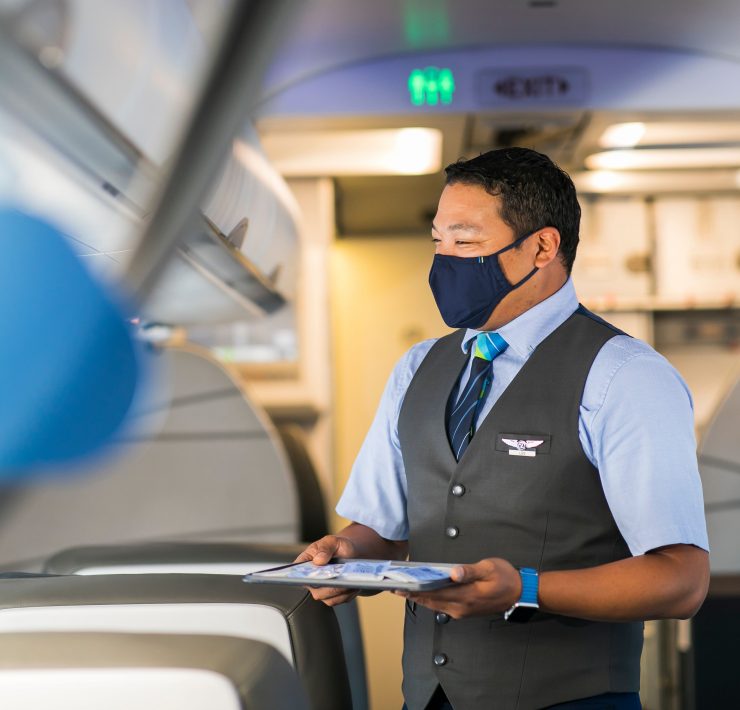 a man wearing a face mask and holding a clipboard