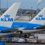 a group of airplanes parked at an airport