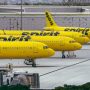 a group of yellow airplanes parked at an airport