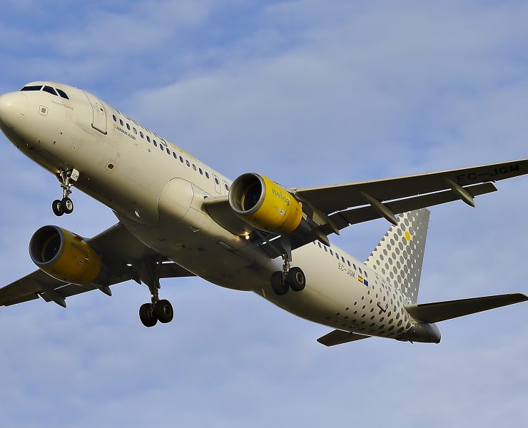 a white airplane with yellow and white spots