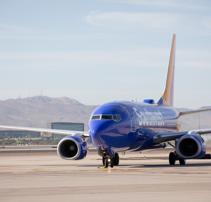 a blue airplane on a runway