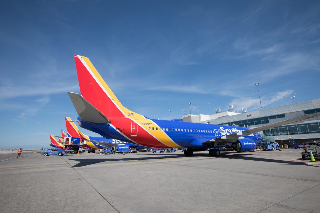 a group of airplanes parked at an airport