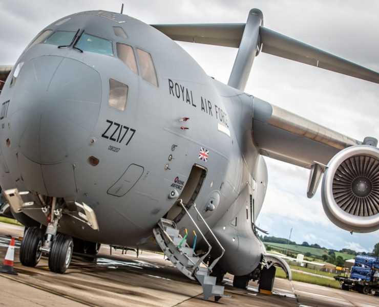 a large grey airplane with a door open