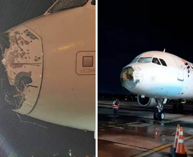 a plane with a broken nose and a man standing next to it