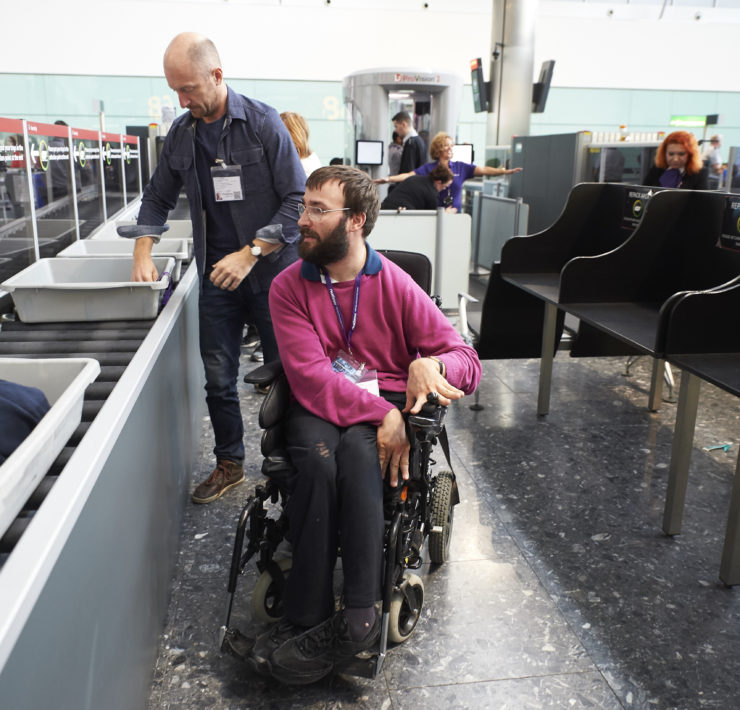 a man in a wheelchair in a airport