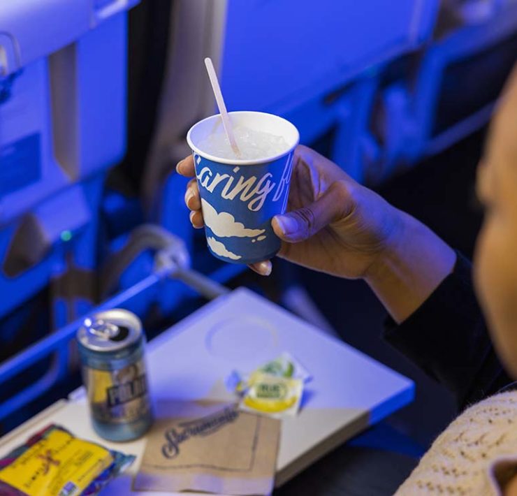 a person holding a cup of beverage