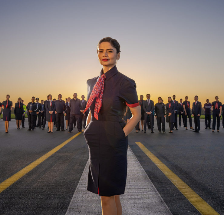 a woman standing in front of a group of people