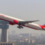 a large airplane flying over a city