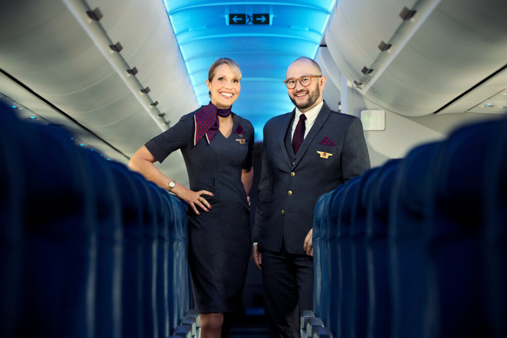 a man and woman standing in an airplane