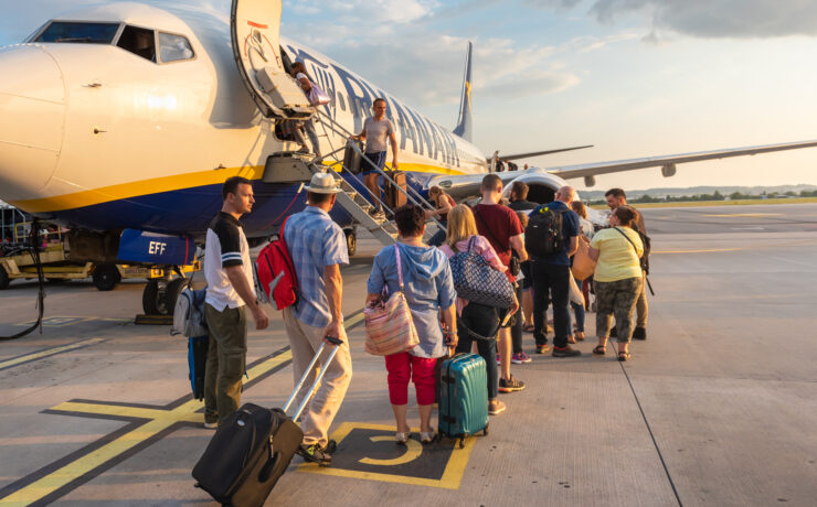 a group of people boarding an airplane