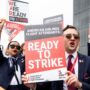 a group of people holding signs