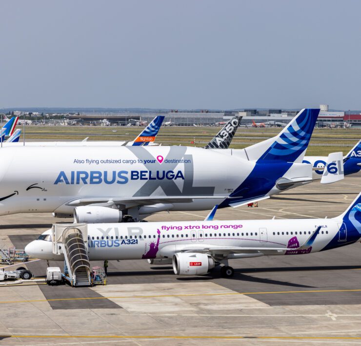 a group of airplanes parked on a runway