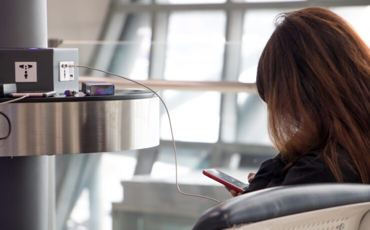 a woman sitting in a chair with a phone in her hand