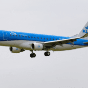 a blue and white airplane in the sky