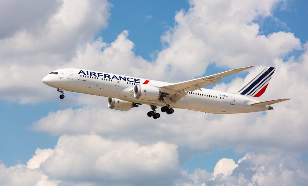 a white airplane flying in the sky