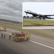 a plane and firetrucks on a runway