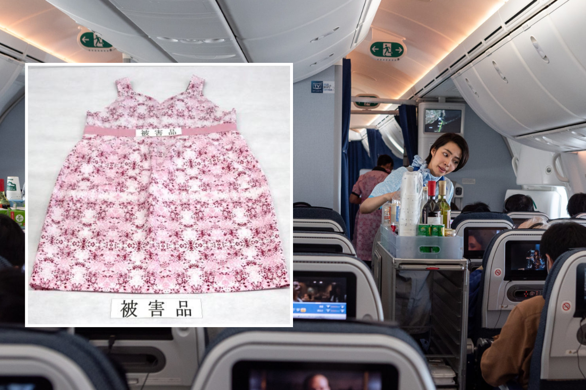 a woman standing in an airplane with a dress on