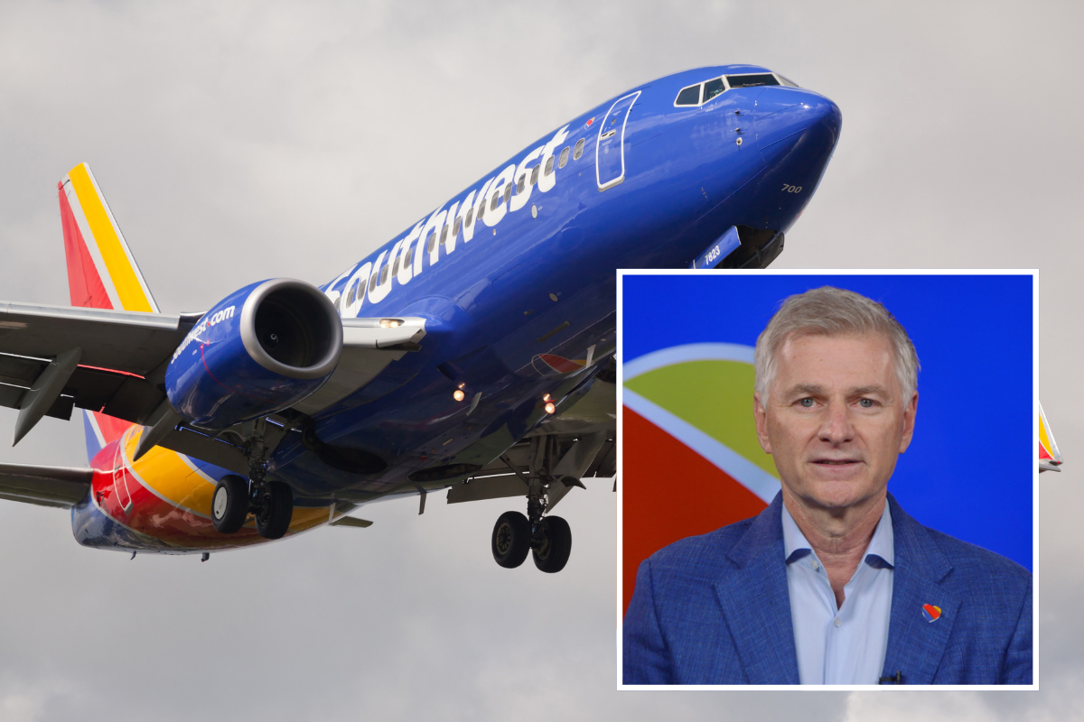 a blue airplane with a man in the background