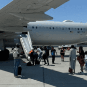 people standing next to an airplane