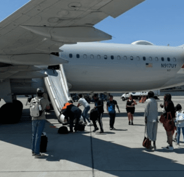 people standing next to an airplane