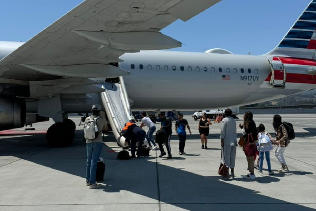 people standing next to an airplane