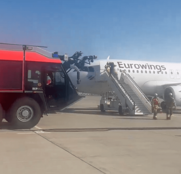 a plane with stairs and people standing next to it