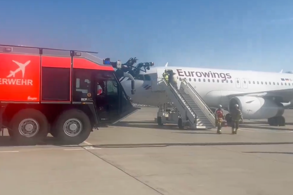 a plane with stairs and people standing next to it