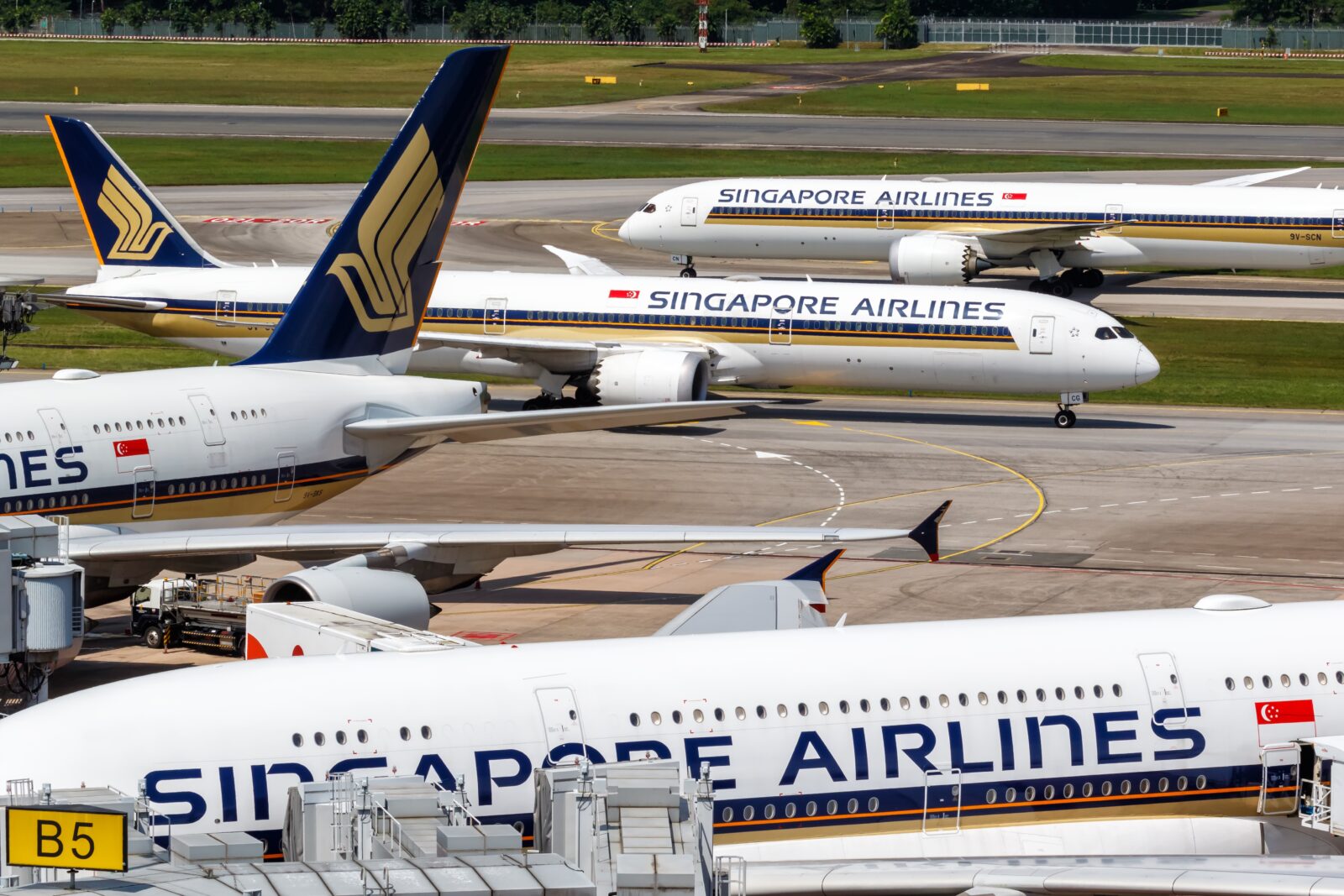 a group of airplanes on a runway