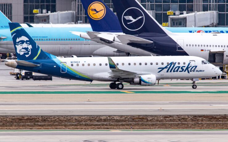 a group of airplanes on a runway