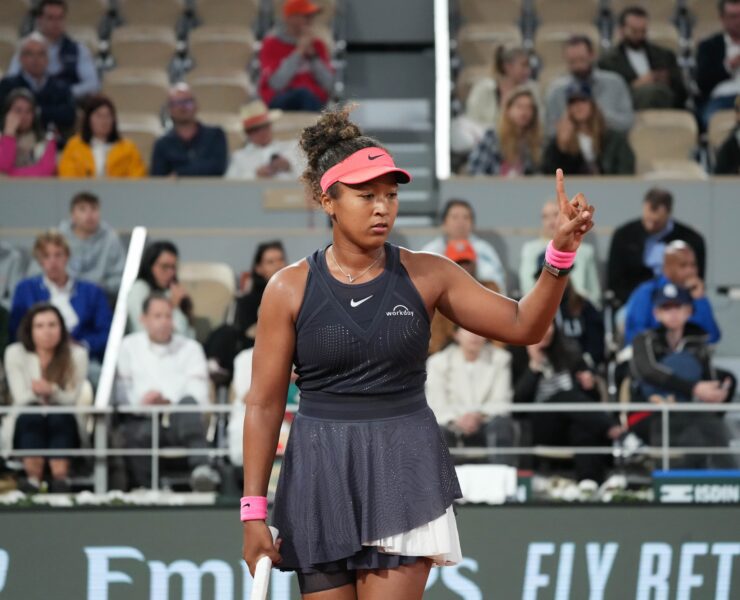 a woman holding a tennis racket