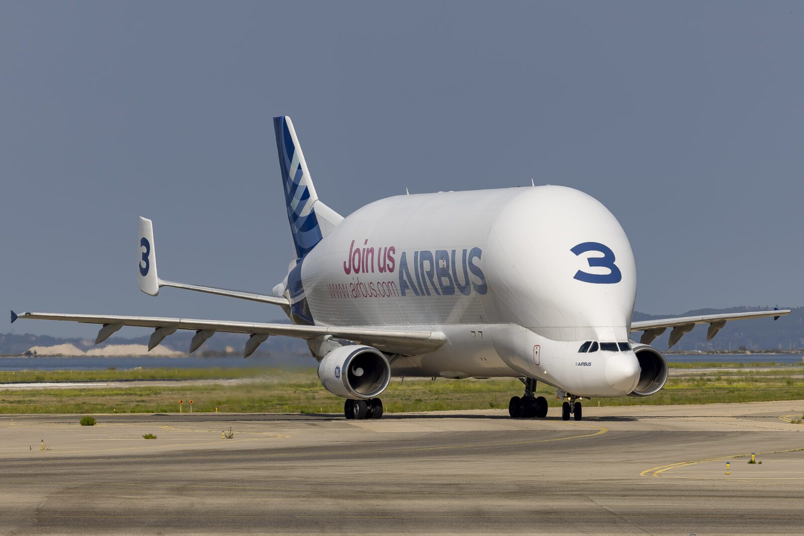 a large white airplane on a runway