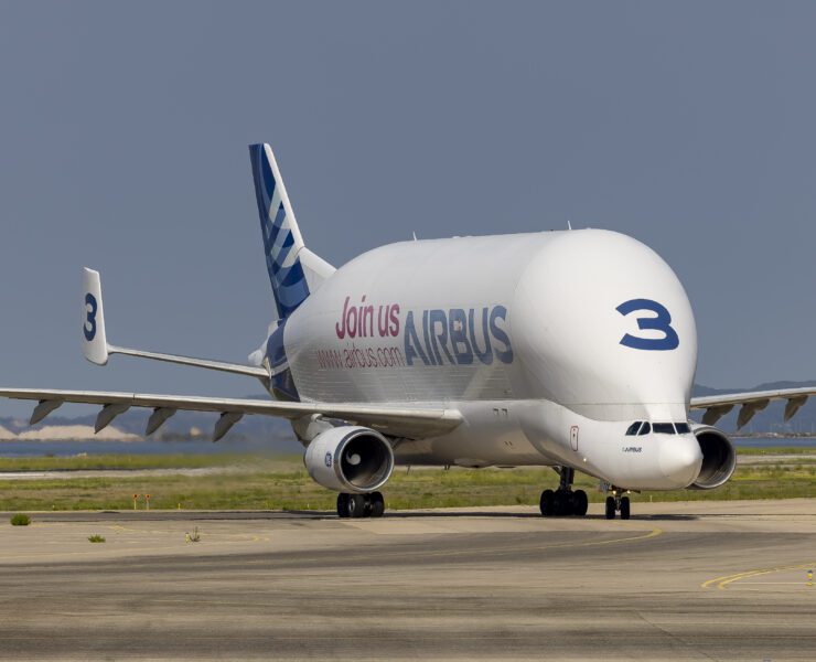 a large white airplane on a runway