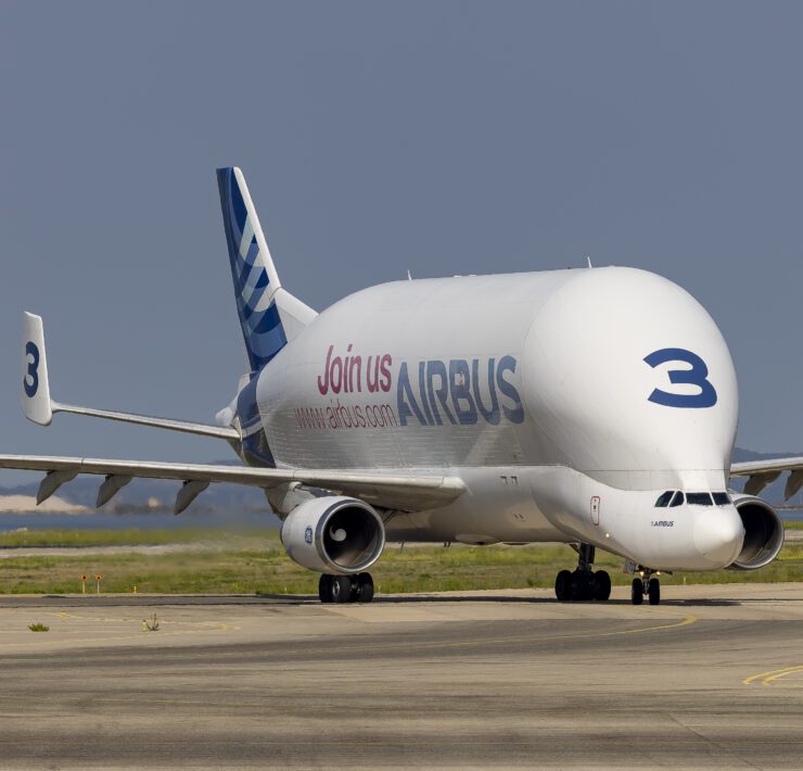 a large white airplane on a runway