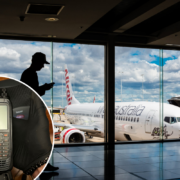 a man using a cell phone in an airport